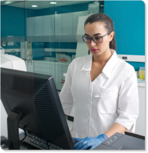 Photo of a lab technician using a computer