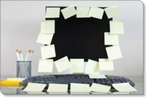 Photo of a computer screen covered in sticky notes
