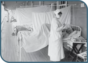 Black and white photo showing a patient on a bed with a nurse standing next to the patient.