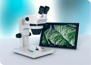 Image of a microscope next to a screen showing an image of a magnified object