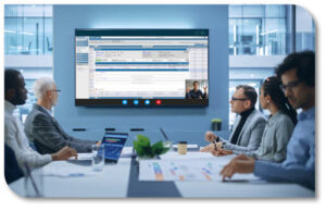Image of people around a conference table watching a software demo on a monitor