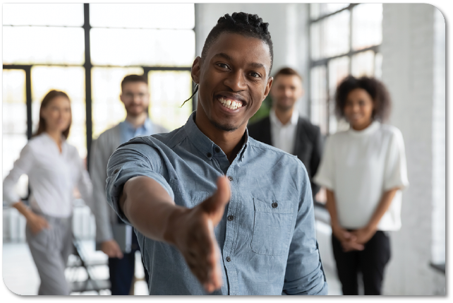 Group of employees with outreached hand for a handshake